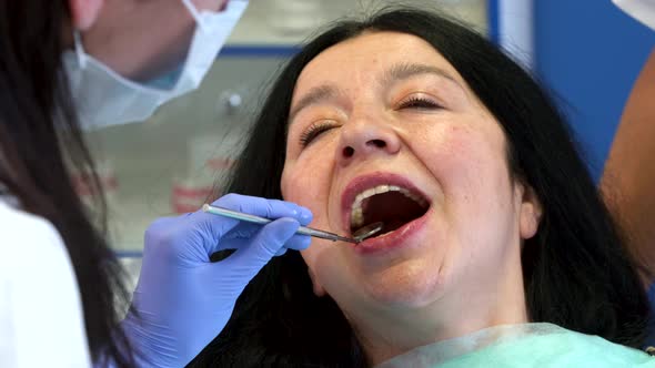 Dentist Checks Up Woman's Teeth