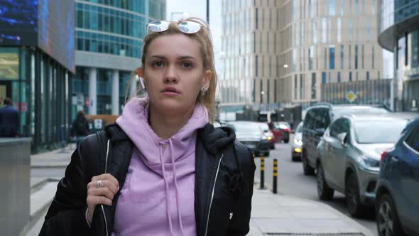 Pretty Girl with Ponytail Going Along Street of Big City alt