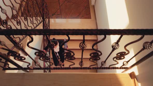 Top View of Business Colleagues Shaking Hands on Stairs alt