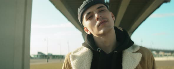 Portrait of Young Handsome Man in Streetwear Outdoors alt