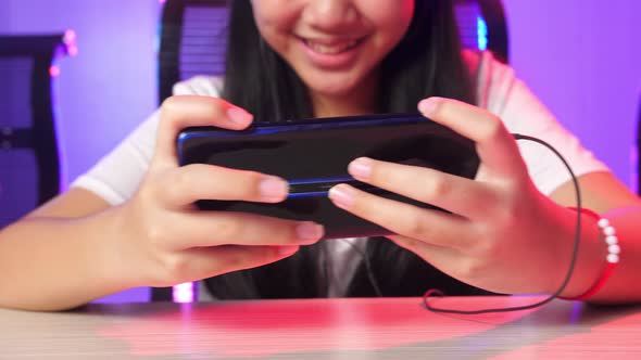 Hands Of Asian Team Gamers Playing In Competitive Video Games By Mobile Phone alt