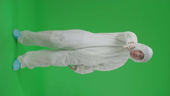Full Body Of Male Wear Protective Uniform Ppe And Showing Thumbs Down, Unlike In Green Screen Studio alt