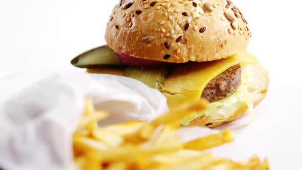 Hamburger and french fries on table alt