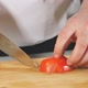 Man Person Cutting Tomato with Sharp Knife on a Wooden Board - VideoHive Item for Sale