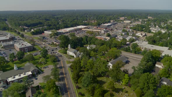 Forward Aerial Pan of a Small Town Amongst Trees in Smithtown Long Island alt