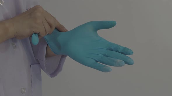Wearing gloves. Male doctor wear blue rubber nitrile hands glove. Footage of Doc putting on gloves.