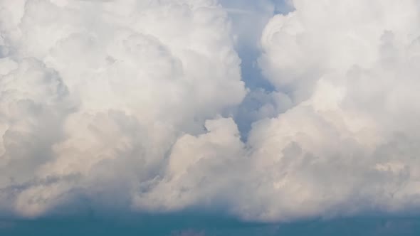 Timelapse of White Puffy Cumulus Clouds Forming on Summer Blue Sky alt