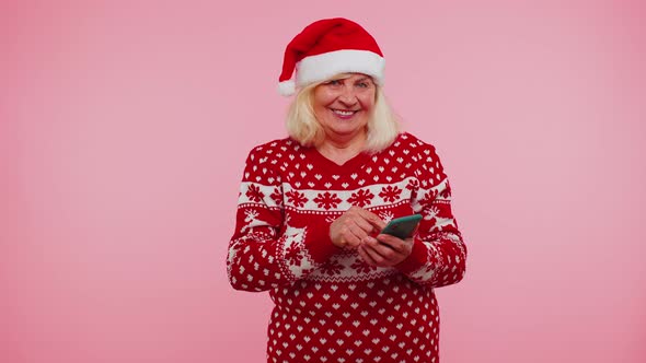 Senior Grandmother Using Mobile Phone Typing New Post on Web Christmas Shopping Online Browsing alt
