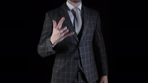 Handsome Businessman Wearing Suit Showing Rock n Roll Sign with His Hand Isolated on Black alt