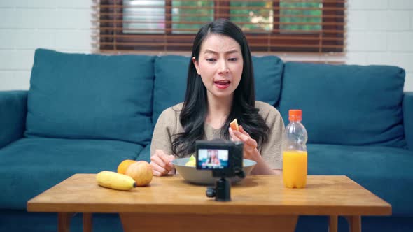 Asian women using camera streaming and recording vlog video about the benefit for broadcast online. alt