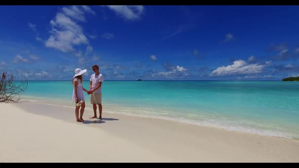 Romantic couple sunbathe on marine sea view beach holiday by blue ocean with white sandy background  alt