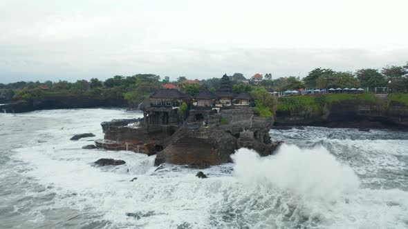Aerial Rotating Shot of Empty Tanah Lot Temple During the Storm in Bali Indonesia alt