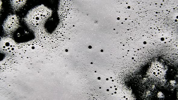 Detergent Disinfectant Is Sprayed Onto Glass in Slow Motion. Cleaning Glass From Dirt and Viruses alt