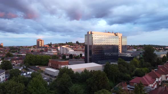 Drone shot rising up over a North London suburb at sunset, England alt