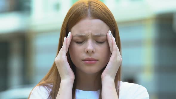 Red-Haired Young Woman Suffering Migraine Massaging Temples, Health Care, Ache alt
