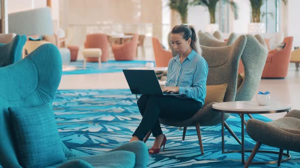Empty Cafe with a Female Freelancer Working on the Laptop alt