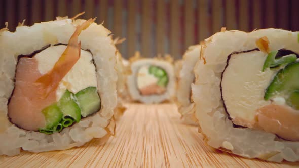 Zoom in Slide Video of Japanese Sushi Roll on Wooden Background alt