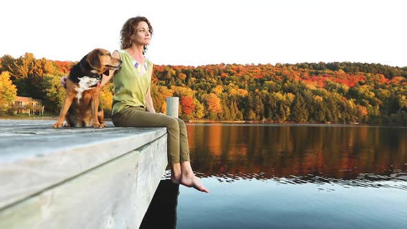 Woman and dog relaxing on the dock