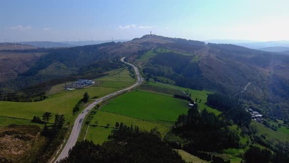 Organic cattle farms in the mountains with green meadows, a two-way road with choches circulating an alt