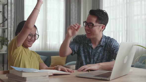 Caring Father Help Daughter Learn Online From Home. Kid Girl Use Laptop Makes Notes And Celebrating alt