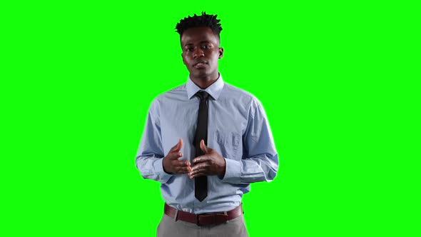 an African American man in suit talking in green background alt