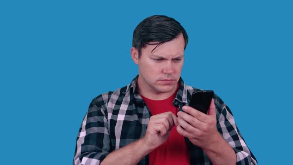 Young Pensive Caucasian Race Man Reading Sms on Smartphone