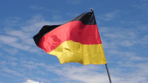 German Flag Waving in the Wind in Slow Motion Close Up with Sky Background alt