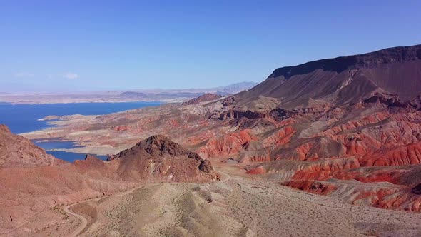 Aerial view overlooking Kingman wash desert and rocky mountains with Lake Mead in the background in alt
