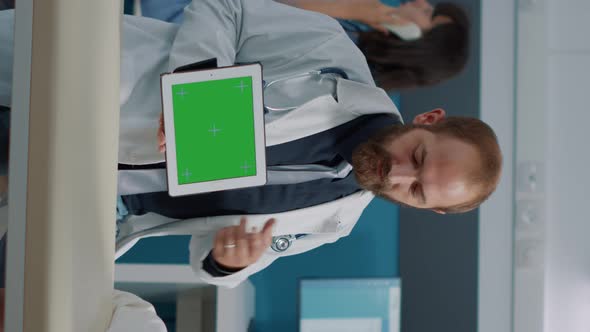 Vertical Video Doctor and Senior Woman Looing at Horizontal Green Screen alt