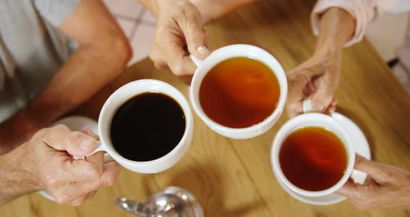 Group of senior friends toasting coffee cups 4k alt