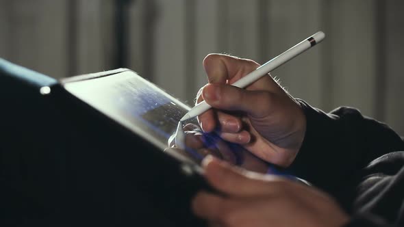 Designer Drawing and Scaling On His Tablet Using Stylus