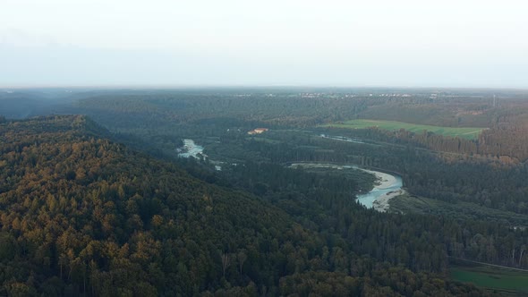 Aerial view over the winding bavarian Isar river behind hills of bavaria alt