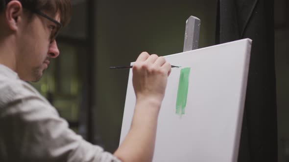 Male Artist Painting On Canvas alt
