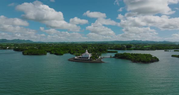 Aerial View of an Indian Temple in the Indian Ocean Lagoon Amidst Lush Green Vegetation Against the alt