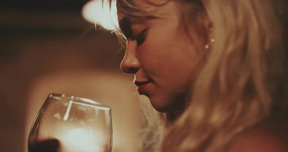 Woman smells and tastes Red Wine alt