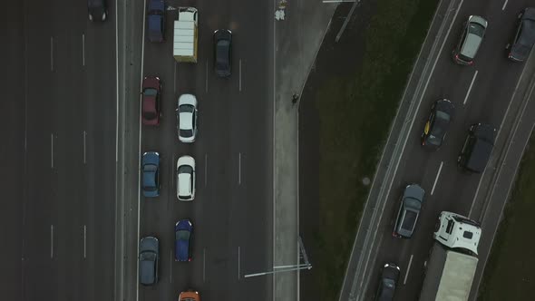 Lowangle Drone Flight Over a Massive Intersection During Early Evening Rush Hour with Cyclists