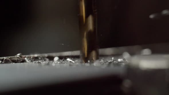 Making Hole in Metal Piece with Spiral Drill in Shop Macro alt