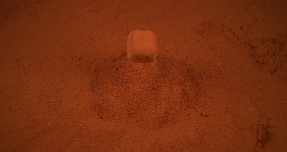 Chocolate Truffle falling on Chocolate Powder, slow motion 4K alt
