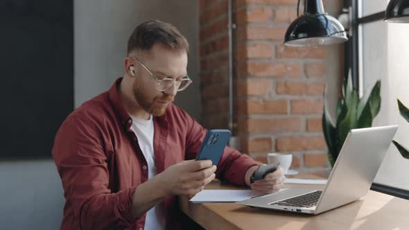 Freelancer Typing Credit Card Number on Mobile Phone While Transferring Money alt