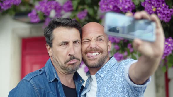 Happy Homosexual Men Doing Selfie and Grimacing at Camera alt