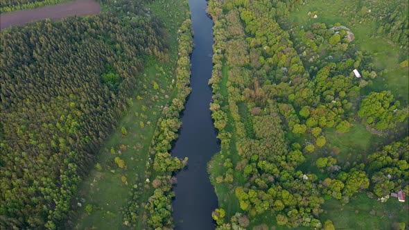 View of the river from above. Flight over water and forest trees from a height alt
