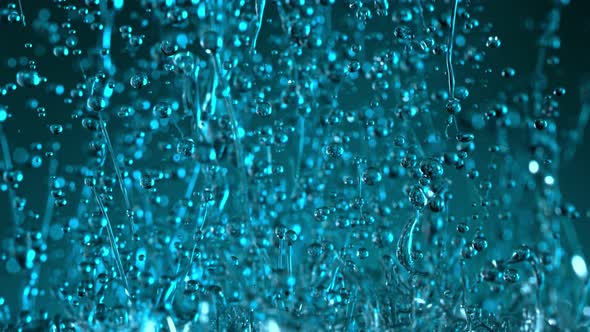 Super Slow Motion Shot of Splashing Blue Liquid on Gradient Background at 1000Fps. alt