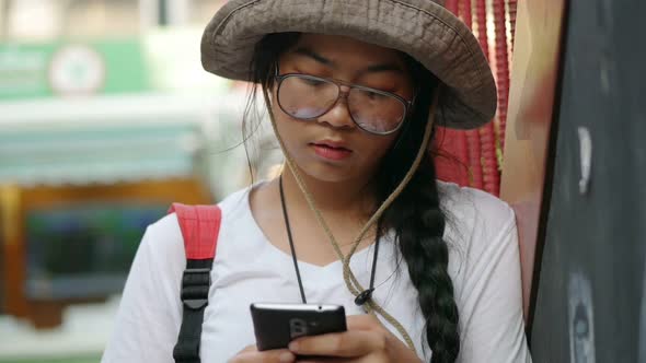 Young Asian woman hand using a smartphone.