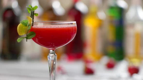 Glass of Red Cocktail Rotates. alt