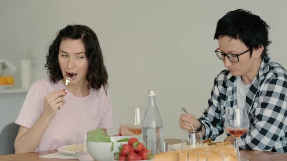 Female Lesbian Couple Eating at Table Having Healthy Food on Kitchen and Wine Rbbro alt