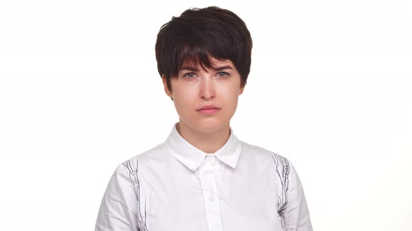 Concentrated Woman in White Skirt Looking with Negation at Camera Isolated Over White Background alt