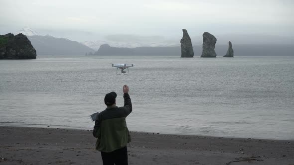 Man Catches Quadcopter in Beach of Pacific Coast After Flying and Shooting