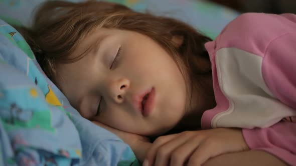 Little girl sleeping in morning light