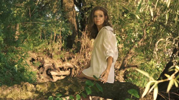 Beautiful Young Sexy Girl In A White Shirt Walks Along River Bank Among Trees alt