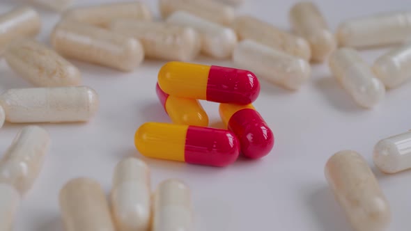 Close Up Pills Tablets Drugs Meds Medications Rotating on White Surface alt